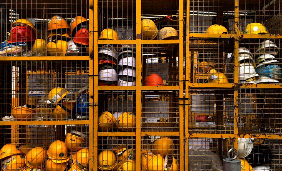 Hard hats stacked in a cage