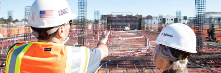 Two construction workers looking over a worksite